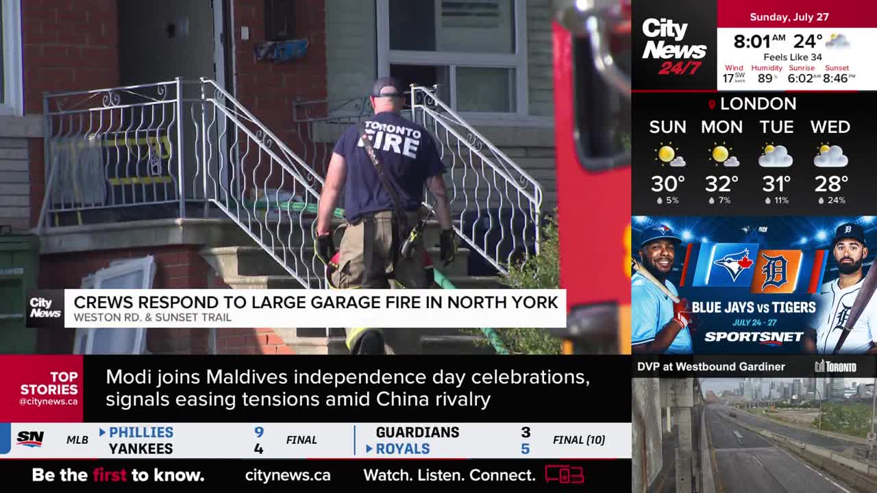 A Toronto Fire Services firefighter walks toward a house on Weston Road, where a garage fire has occurred. CityNews Toronto is reporting on the scene.
