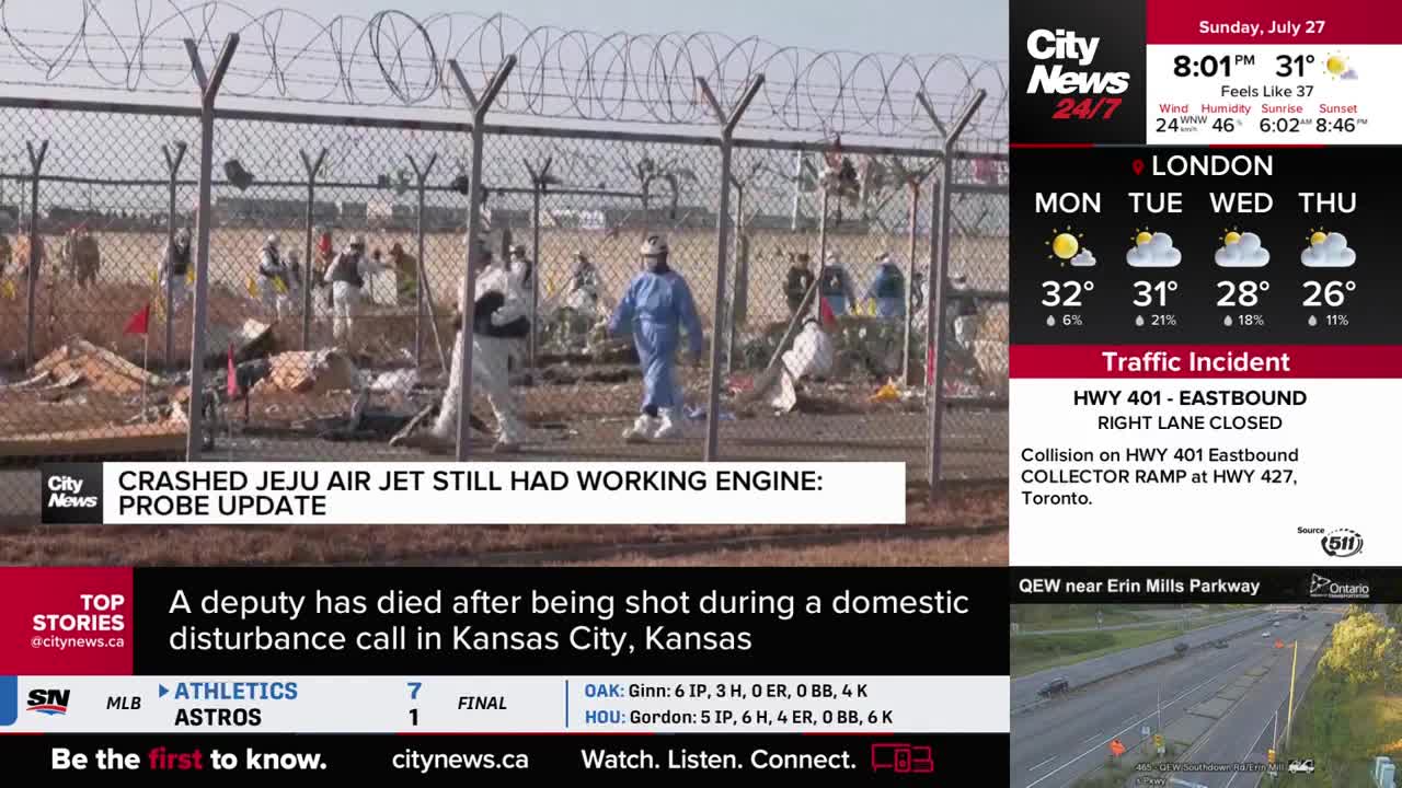 Behind a wire fence, people in protective suits are moving around a debris field. The CityNews Toronto report indicates this is related to a crashed Jeju Air jet.
