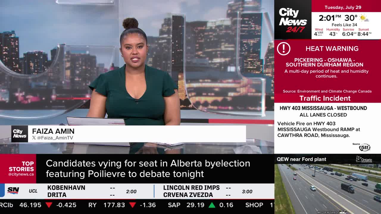 Faiza Amin, from CityNews Toronto, is speaking directly into the camera, her dark green top a sharp contrast to the background. A heat warning for the Pickering-Oshawa-Southern Durham region is displayed, along with news of a traffic incident on Highway 403 in Mississauga.
