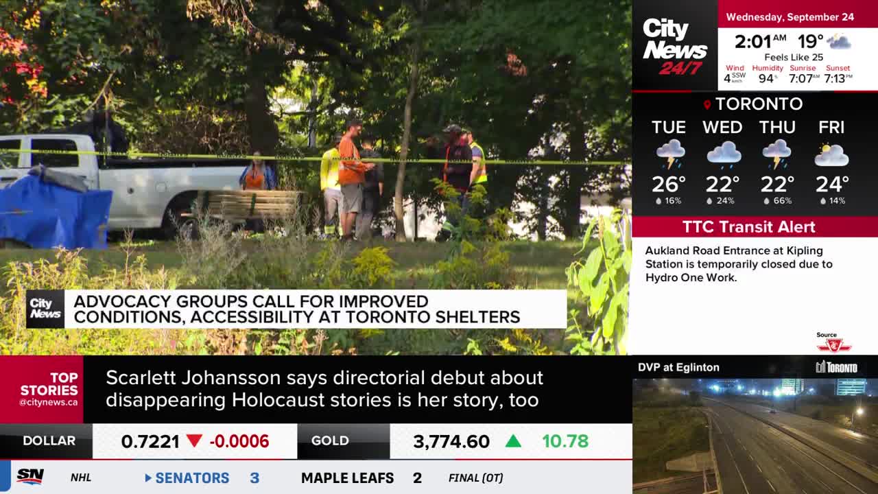 A white pickup truck sits behind yellow caution tape, with several people gathered nearby. CityNews Toronto is reporting on a scene where advocacy groups are calling for better conditions at Toronto shelters.

