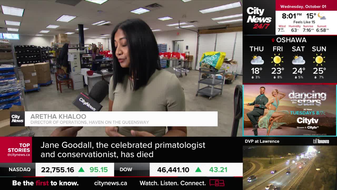 A CityNews Toronto reporter is interviewing a woman in a warehouse. The director of operations for Haven on the Queensway is speaking into a microphone, with boxes and shelving visible in the background.
