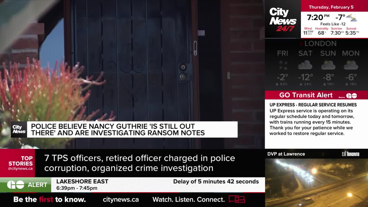 A dark wooden door stands closed, with a leafy plant to its left.  CityNews Toronto is reporting that police believe Nancy Guthrie is still out there and are investigating ransom notes.