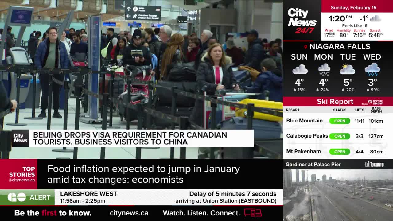 A line of people with luggage waits at airport security. A CityNews Toronto banner announces Beijing is dropping its visa requirement for Canadian tourists.