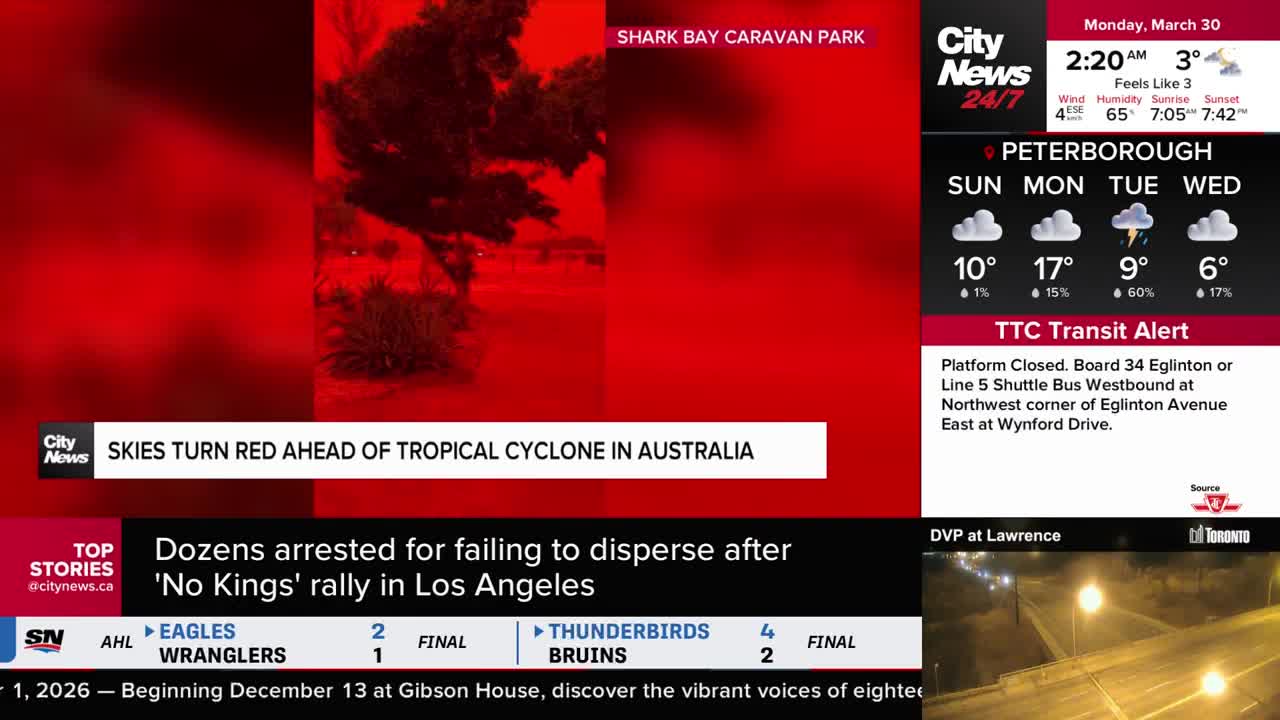 The sky over Shark Bay Caravan Park is an intense red, hinting at the approaching tropical cyclone. A CityNews Toronto broadcast shows this dramatic scene alongside local weather updates and transit alerts.