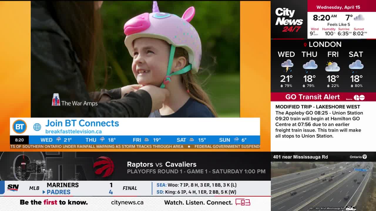 A child's head is tilted up, a bright pink unicorn helmet being fastened around it. On the right, CityNews Toronto displays a weather forecast for London and a GO Transit alert about a modified Lakeshore West train.