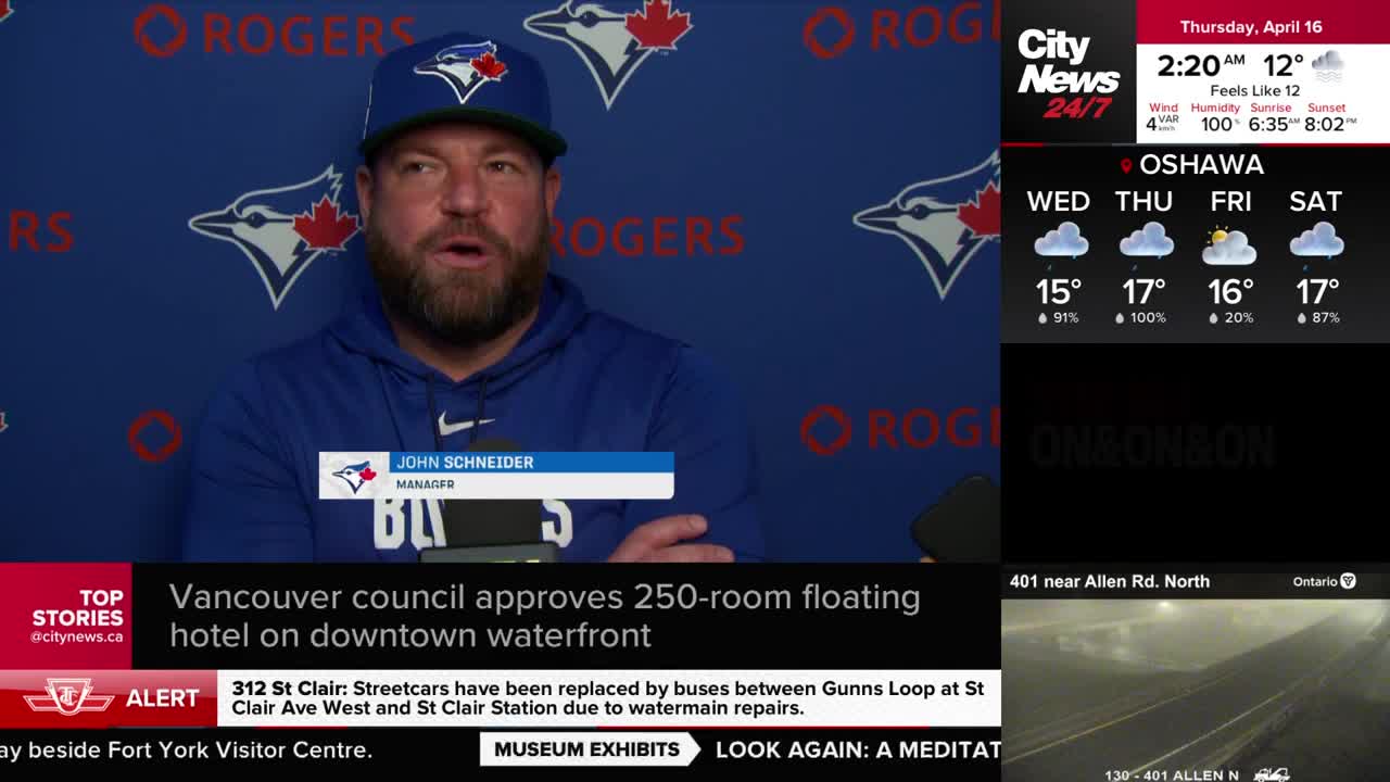 John Schneider, manager for the Toronto Blue Jays, speaks at a press conference. A CityNews Toronto graphic displays weather forecasts for Oshawa.