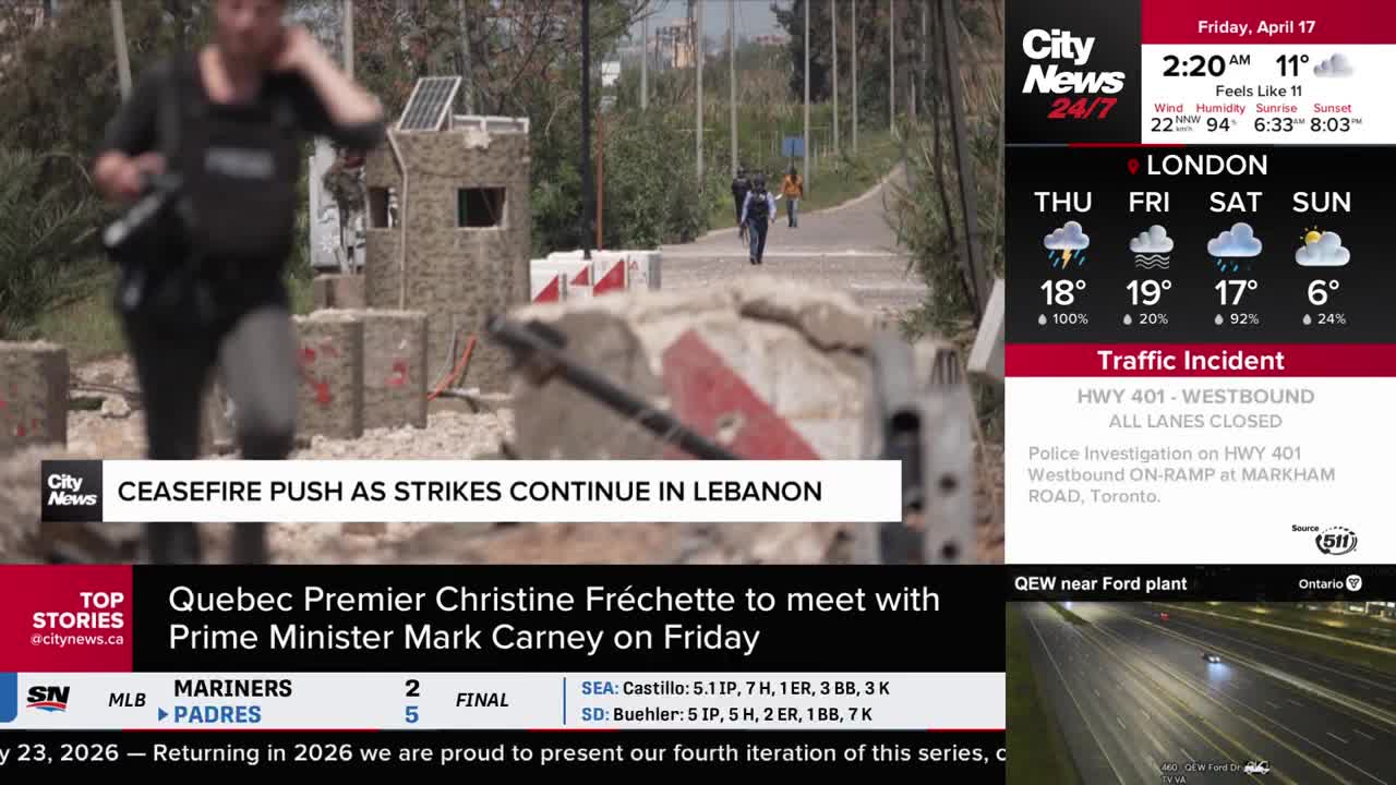 A person in a vest walks past a makeshift barrier, with others further down a road. The CityNews Toronto ticker announces a ceasefire push as strikes continue in Lebanon.