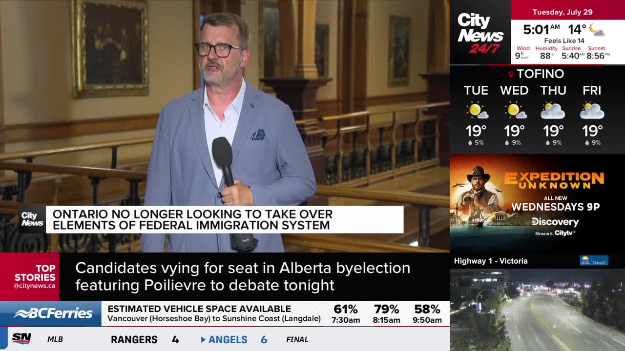 A CityNews Vancouver reporter, holding a microphone, is speaking in what looks like a government building. The screen below him reports on Ontario and immigration.
