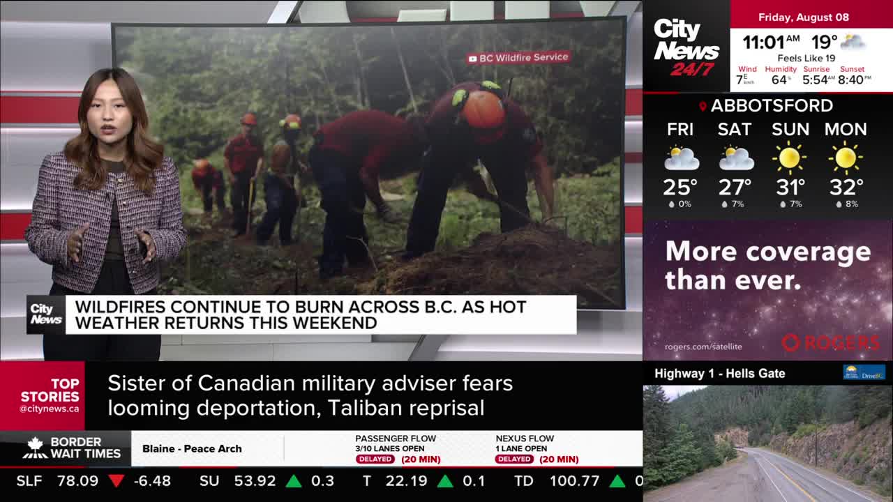 A CityNews Vancouver reporter stands in front of a screen displaying footage of firefighters. They are digging in the dirt, and the BC Wildfire Service logo is visible in the corner.
