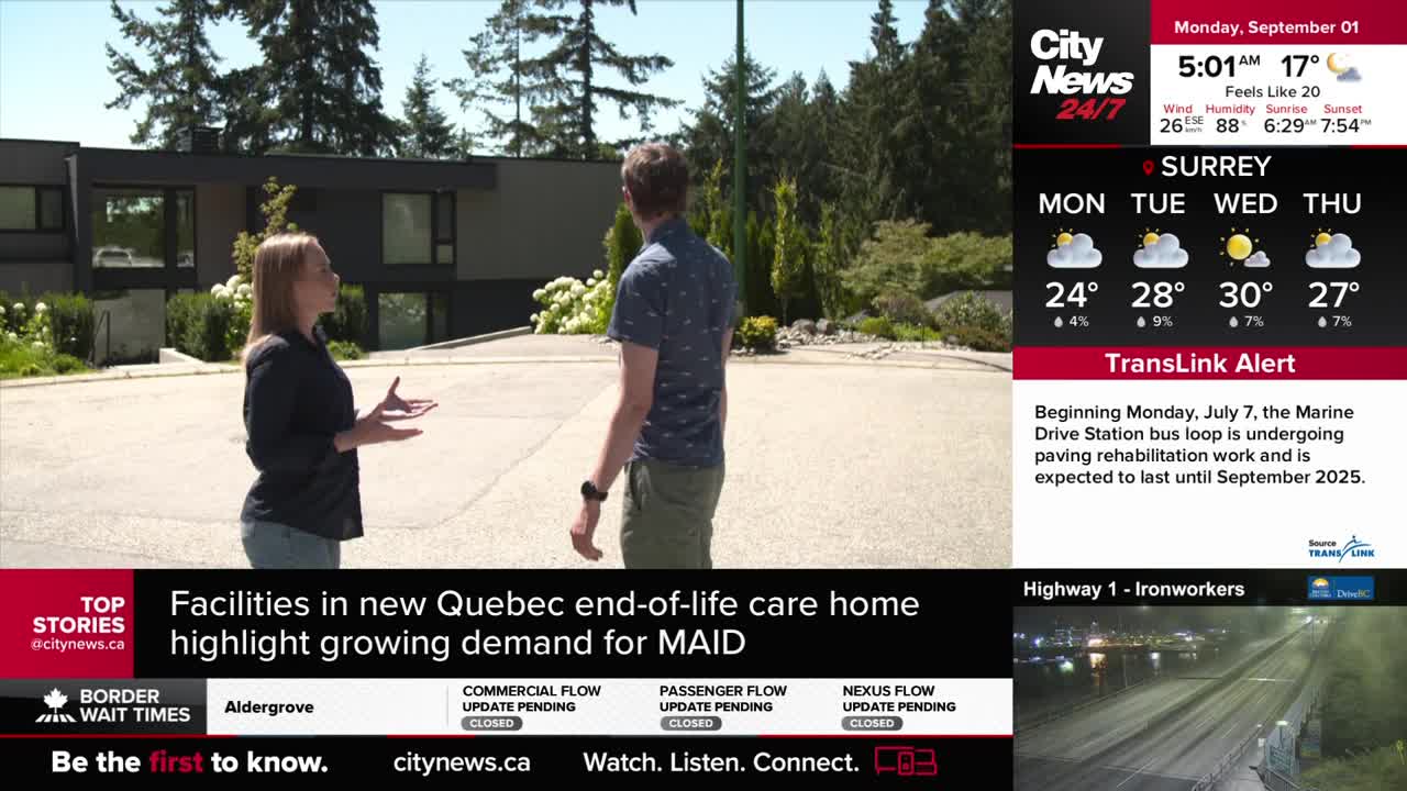 A CityNews Vancouver reporter gestures towards a modern building while speaking to a man. The weather report shows a sunny forecast for Surrey, British Columbia.
