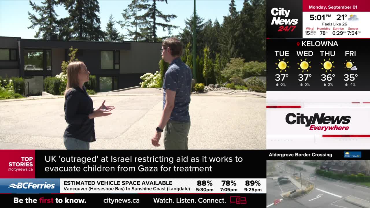 A CityNews Vancouver reporter gestures while speaking to a man on a driveway, a modern house behind them. The weather forecast for Kelowna is displayed nearby.
