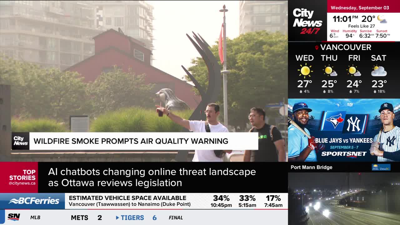 A man in a white shirt points a phone towards a sculpture, with a CityNews Vancouver graphic highlighting an air quality warning. The sky is hazy, and the news ticker mentions wildfire smoke.
