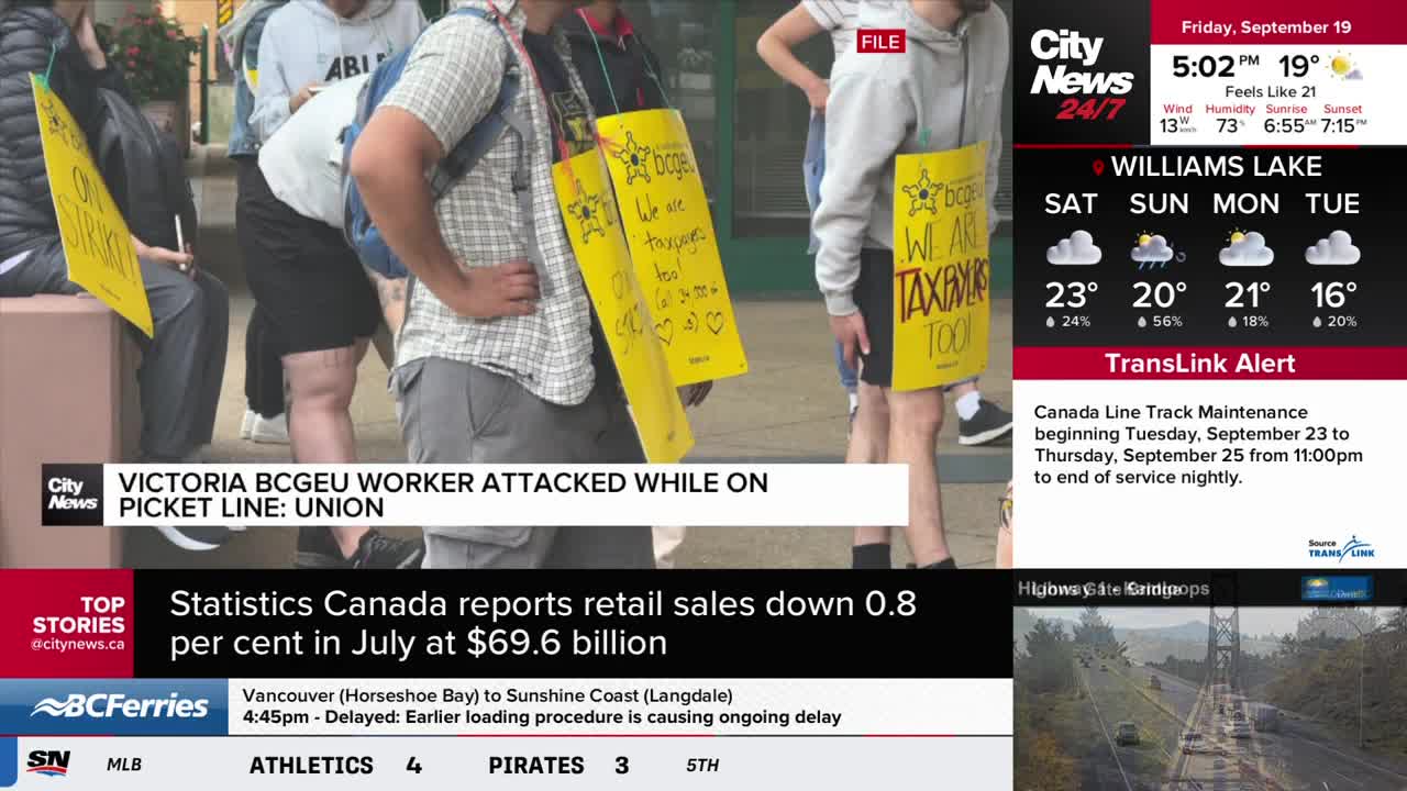 Protesters stand on a sidewalk, wearing yellow signs around their necks. CityNews Vancouver reports a BCGEU worker was attacked on the picket line.
