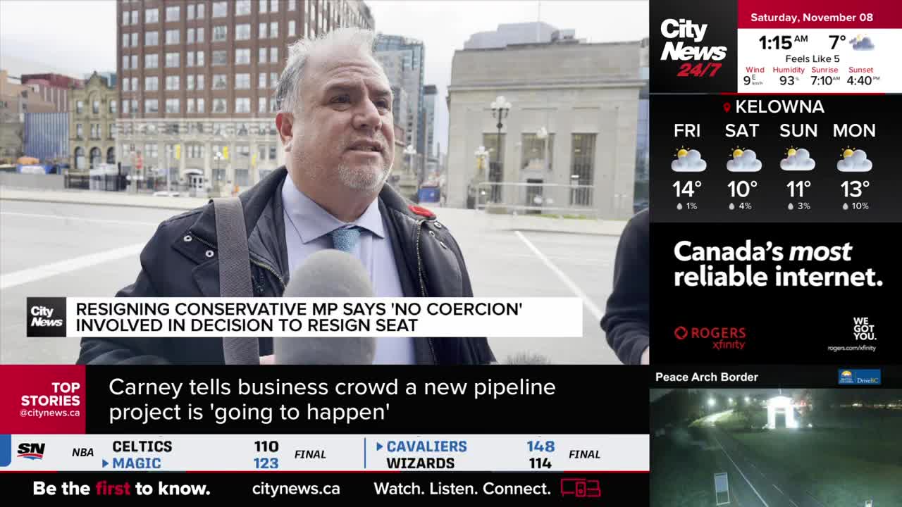 A man in a suit jacket speaks into a microphone, likely for CityNews Vancouver, with a headline about a Conservative MP's resignation displayed on the screen. The weather forecast for Kelowna is visible in the background.
A man in a suit jacket speaks into a microphone, likely for CityNews Vancouver, with a headline about a Conservative MP's resignation displayed on the screen. The weather forecast for Kelowna is visible in the background.