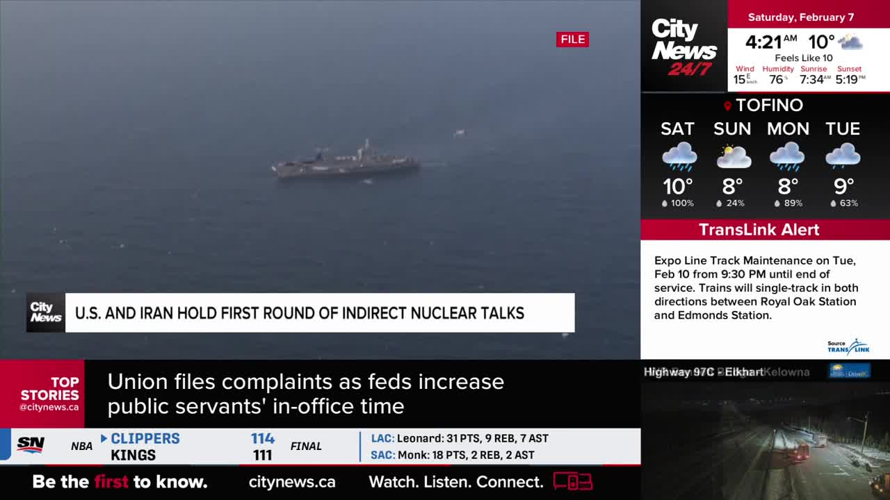 A large naval vessel cuts through calm, grey water. The CityNews Vancouver broadcast displays headlines about nuclear talks and public servant work hours.