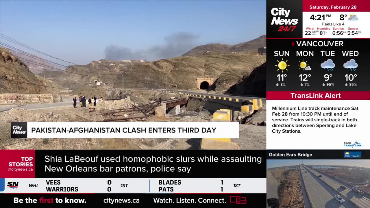 Smoke billows from the hillsides where a border clash continues. A damaged bridge lies across a rocky pass, with a tunnel visible in the distance. Smoke billows from the hillsides where a border clash continues. A damaged bridge lies across a rocky pass, with a tunnel visible in the distance.