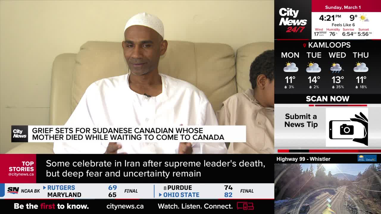 A man in a white cap and robe sits on a couch, his expression somber. Beside him, a young person looks down, their face obscured. A news ticker scrolls below, reporting on a Sudanese Canadian's grief. A man in a white cap and robe sits on a couch, his expression somber. Beside him, a young person looks down, their face obscured. A news ticker scrolls below, reporting on a Sudanese Canadian's grief.