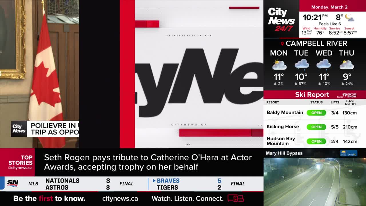 A Canadian flag hangs beside a portrait, with "CityNews" emblazoned across a large screen. A news ticker scrolls below, reporting on Seth Rogen's tribute to Catherine O'Hara at the Actor Awards.