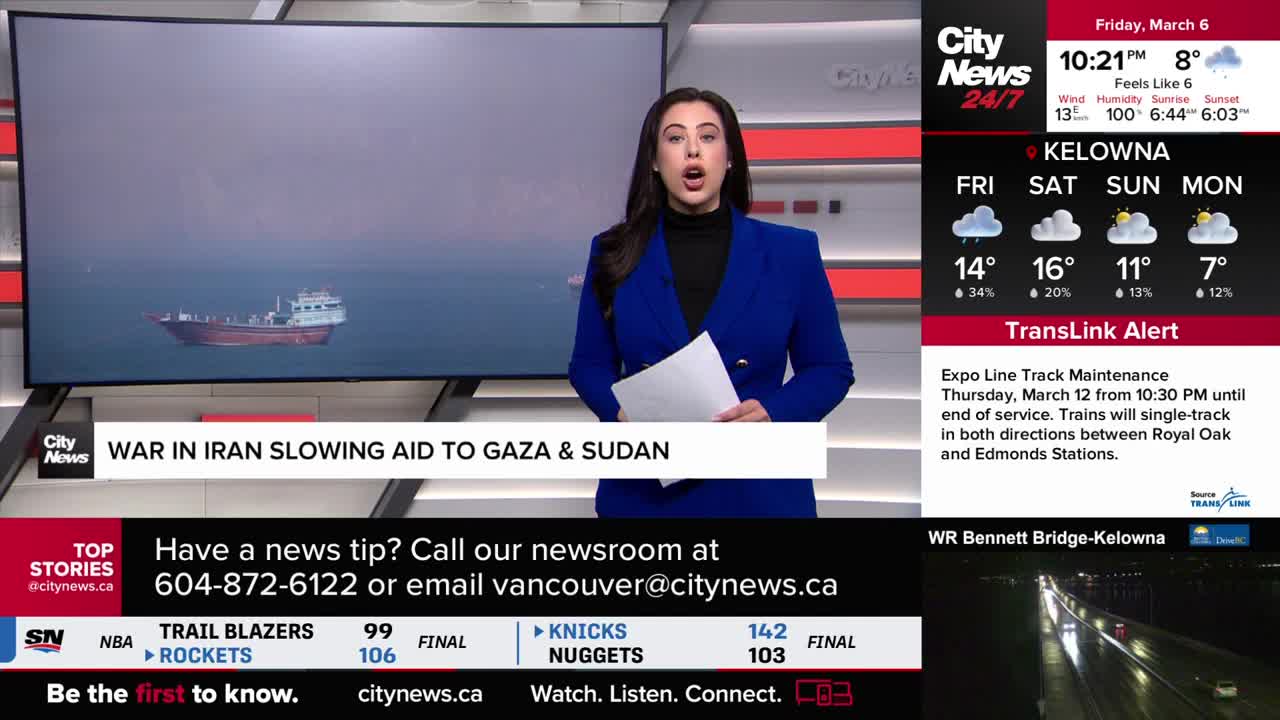 A cargo ship moves slowly on a vast, calm sea. A news anchor in a bright blue blazer stands at a podium, holding papers.