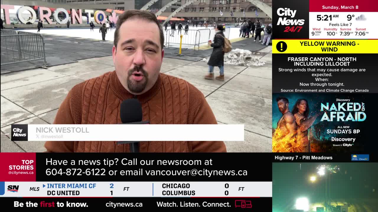A reporter stands in front of a large "TORONTO" sign with an outdoor skating rink behind him. People are skating and walking around the rink, some near piles of snow.