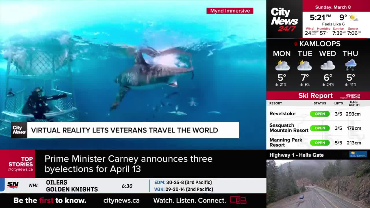 A diver is in a cage, watching a large shark swim past in the clear blue water. CityNews Vancouver reports that Prime Minister Carney is announcing three byelections for April 13.