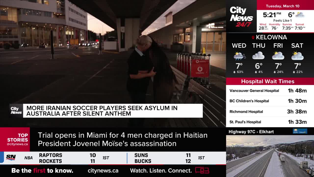 Two people embrace outside a building, their faces hidden. A CityNews Vancouver graphic announces Iranian soccer players seeking asylum.