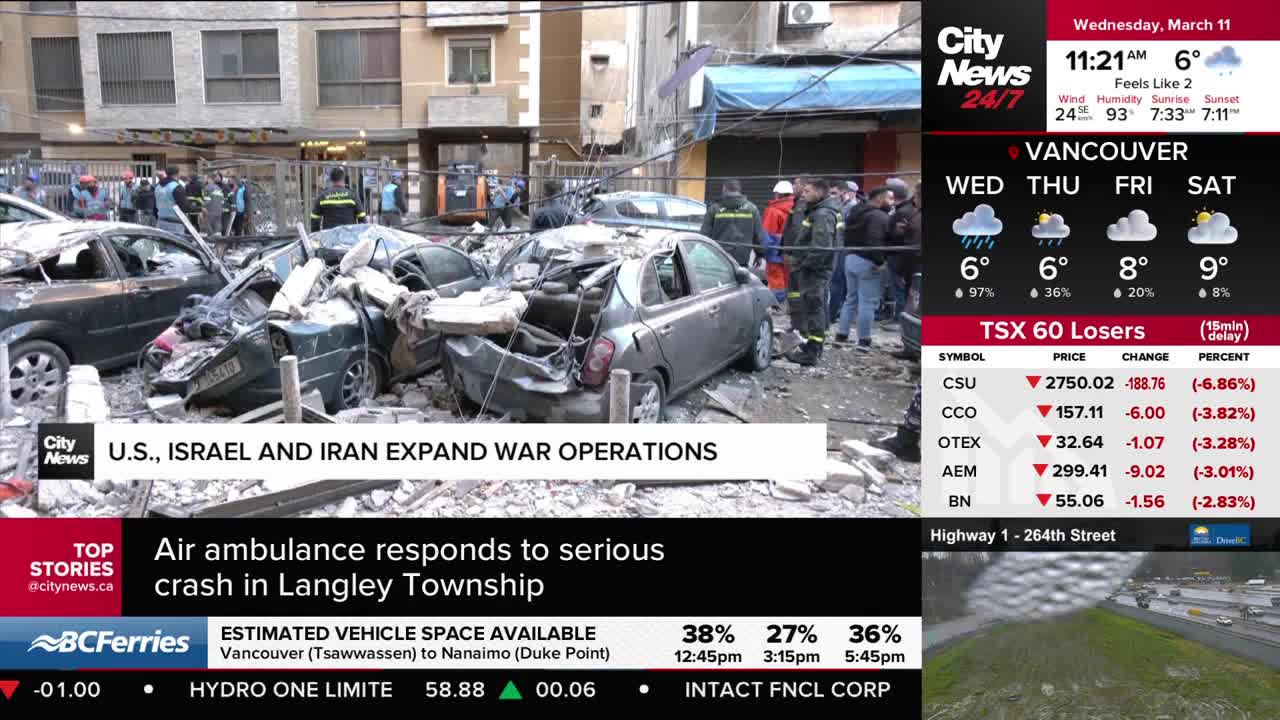 Emergency responders are sifting through a pile of mangled cars after a serious crash in Langley Township, BC. The scene is chaotic, with debris scattered everywhere and several vehicles crushed.