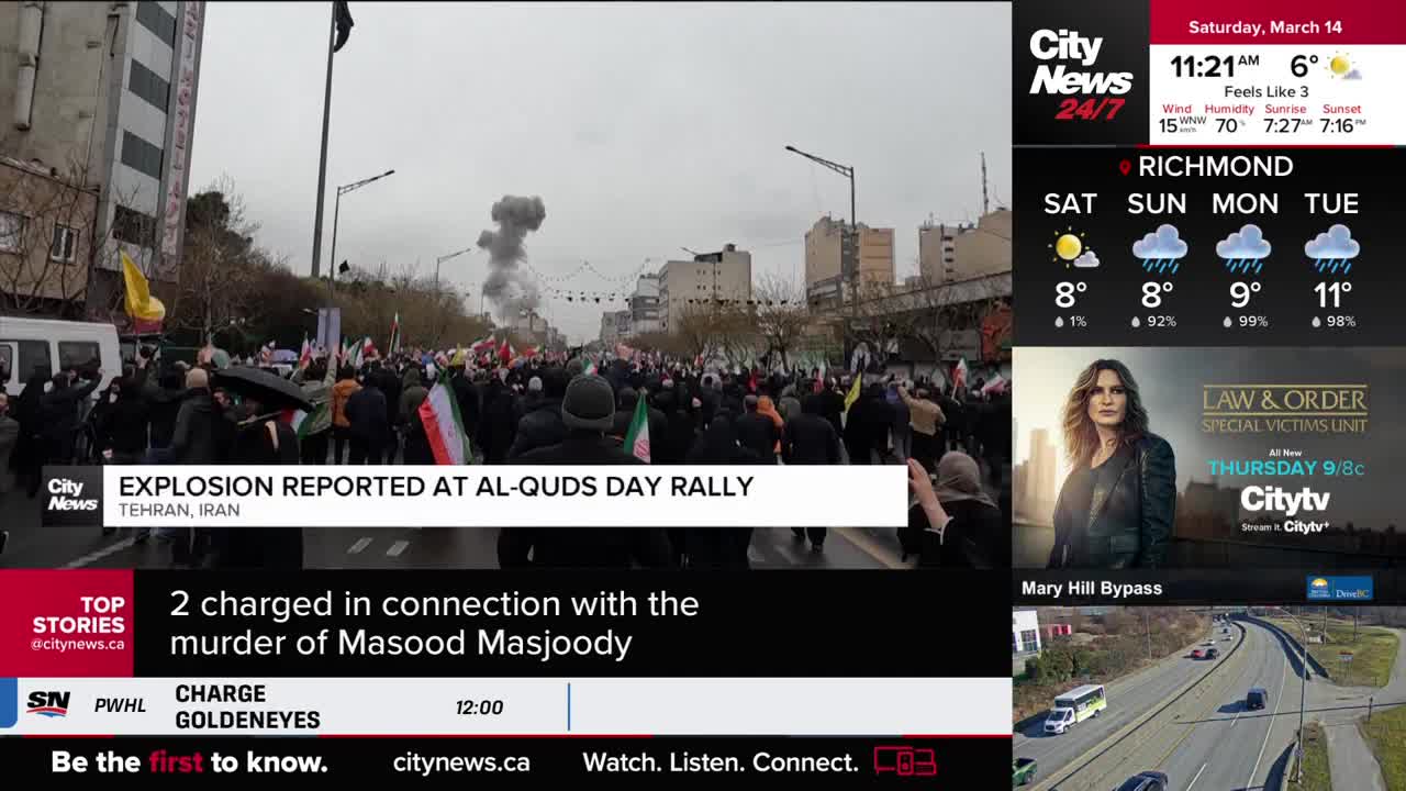 A thick plume of smoke rises into the sky above a crowded street filled with people holding flags. CityNews Vancouver reports an explosion occurred at the Al-Quds Day rally in Tehran, Iran. A thick plume of smoke rises into the sky above a crowded street filled with people holding flags. CityNews Vancouver reports an explosion occurred at the Al-Quds Day rally in Tehran, Iran.
