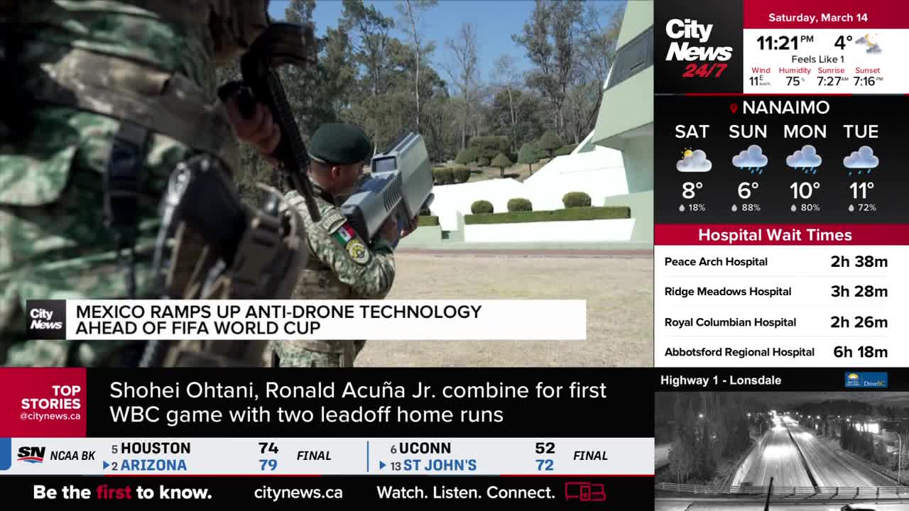 A soldier in fatigues aims a grey, rifle-like device, its screen glowing. Another soldier stands behind him, also holding a rifle, as they practice anti-drone technology in what looks like a training exercise. A soldier in fatigues aims a grey, rifle-like device, its screen glowing. Another soldier stands behind him, also holding a rifle, as they practice anti-drone technology in what looks like a training exercise.