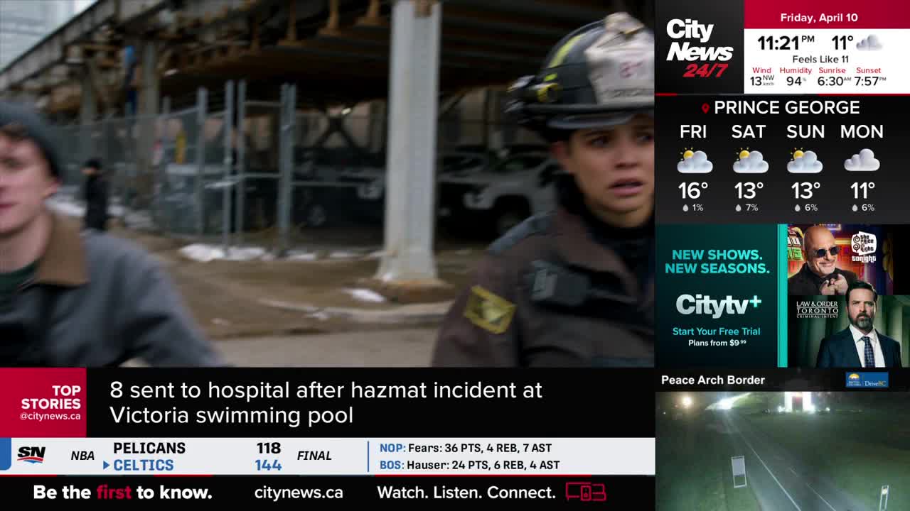 A firefighter in a helmet and uniform rushes forward, her expression tense. Behind her, another person in a grey jacket moves quickly, looking back.