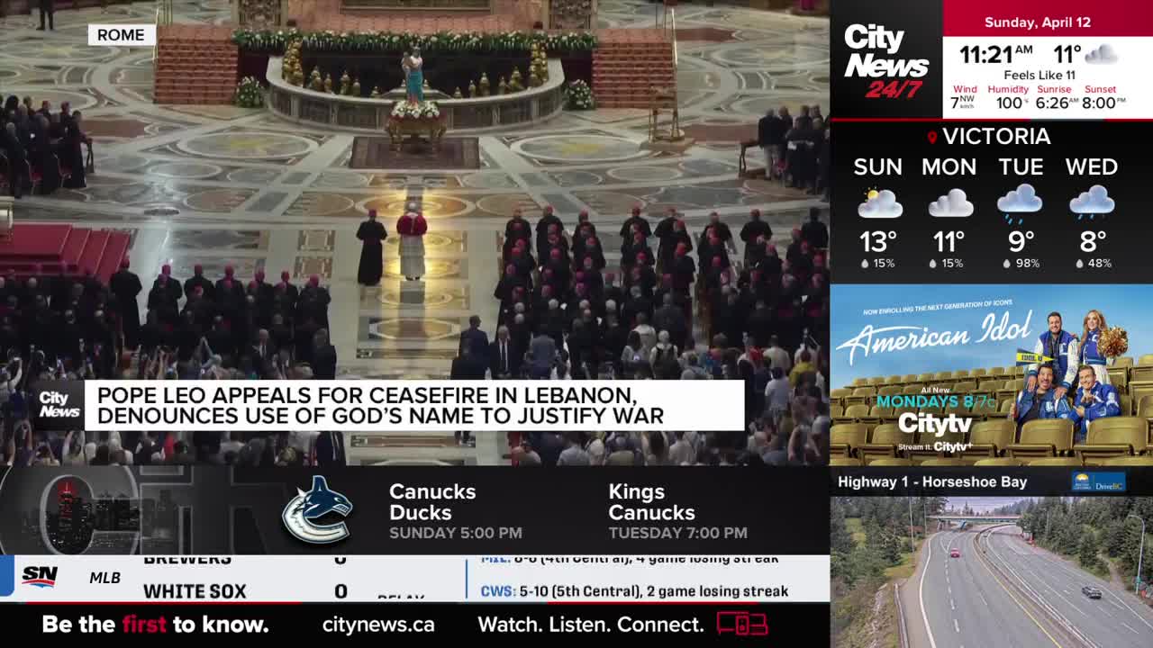 A large group of people in clerical robes fills the vast space, facing a figure in red and white. The CityNews Vancouver ticker scrolls across the bottom, showing sports scores and weather updates for Victoria.