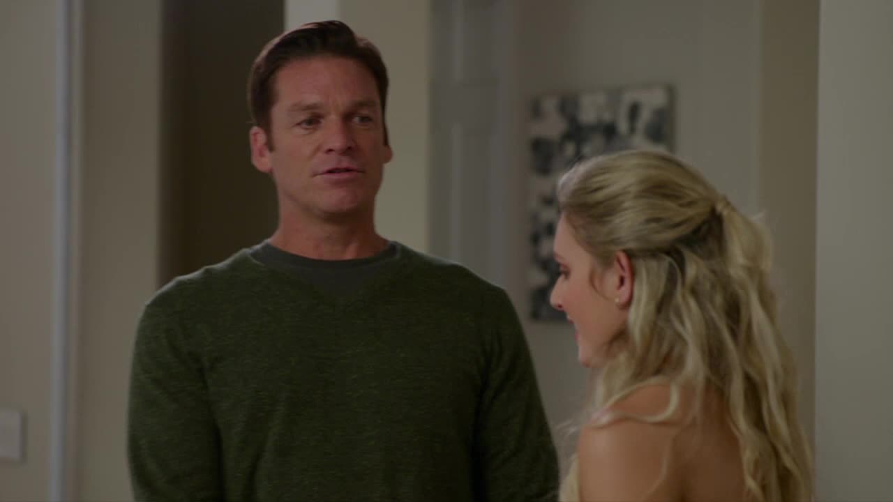 The man in the green sweater is talking, his expression open. The woman with blonde hair is turned toward him, smiling slightly.
