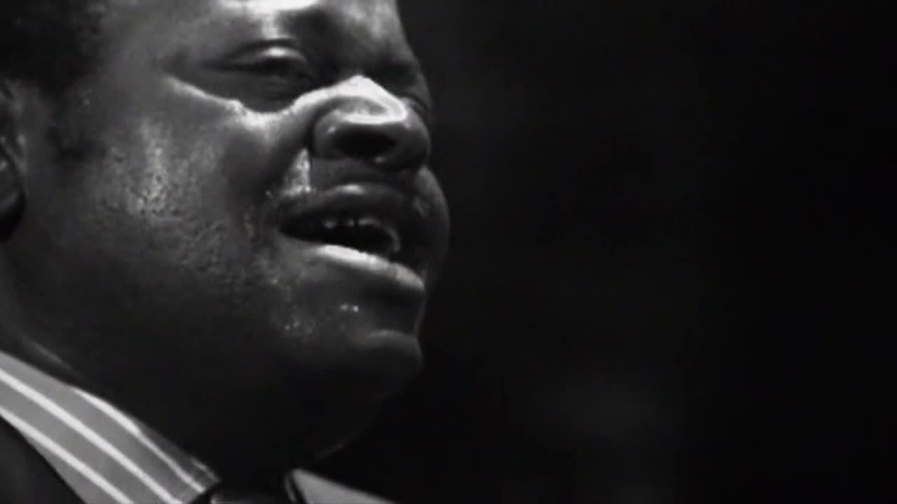 The man's face is illuminated, beads of sweat glistening on his skin. His mouth is open, as if he's singing with passion on Crave 4.
