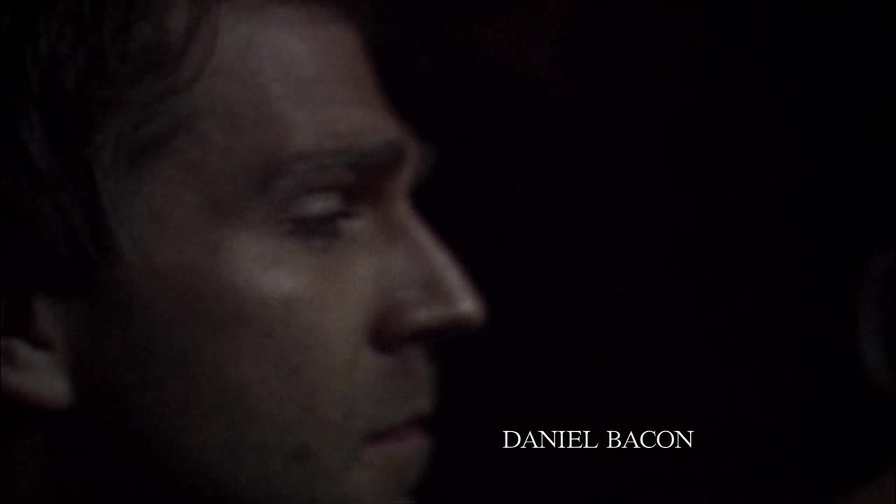 A man's face is partially lit, his profile visible against a dark background. The name "DANIEL BACON" appears in white text, suggesting this is a Canadian production on Crave 4.
