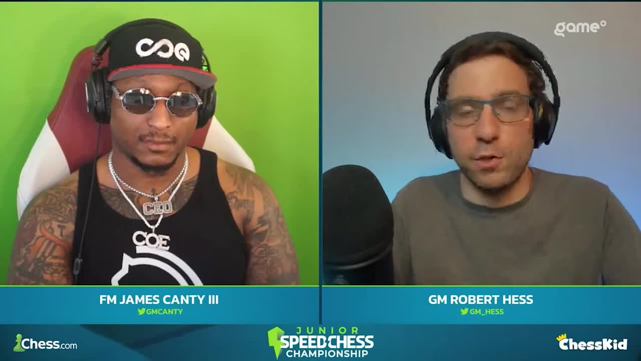 Two commentators, one in a black tank top and sunglasses, the other in a grey shirt and glasses, are speaking into microphones. They're on a split screen, likely broadcasting a Junior Speed Chess Championship, as indicated by the logos.
