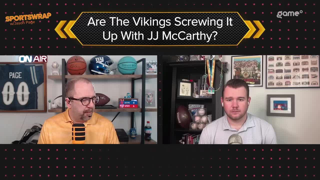 Two men are positioned in front of microphones, seemingly engaged in a discussion about the Vikings and JJ McCarthy, as the Game+ logo sits in the corner. The set is decorated with sports memorabilia, including footballs and helmets.
