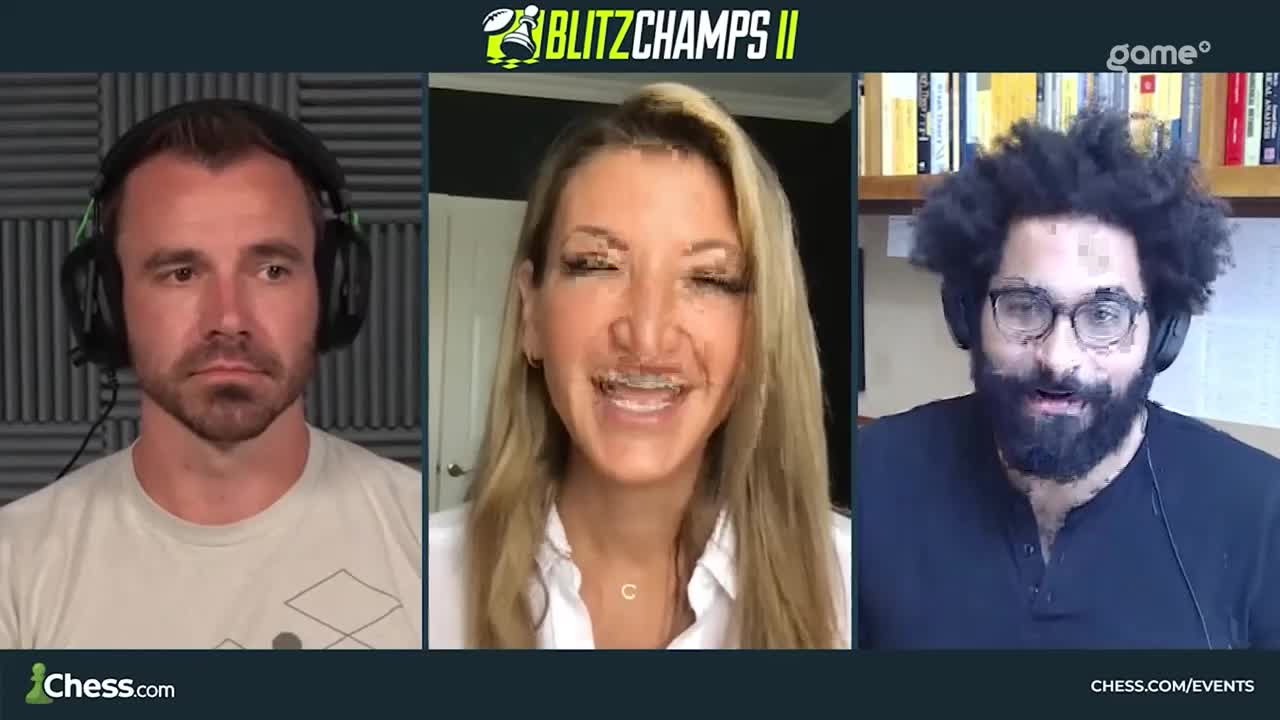 Three people wearing headphones are framed in individual video feeds, likely a live broadcast. The woman in the middle is smiling, while the other two men appear to be listening intently.
