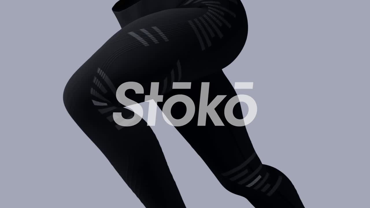 A runner's legs, clad in black compression gear, are mid-stride. The patterned details on the fabric catch the light as the legs pump forward.
