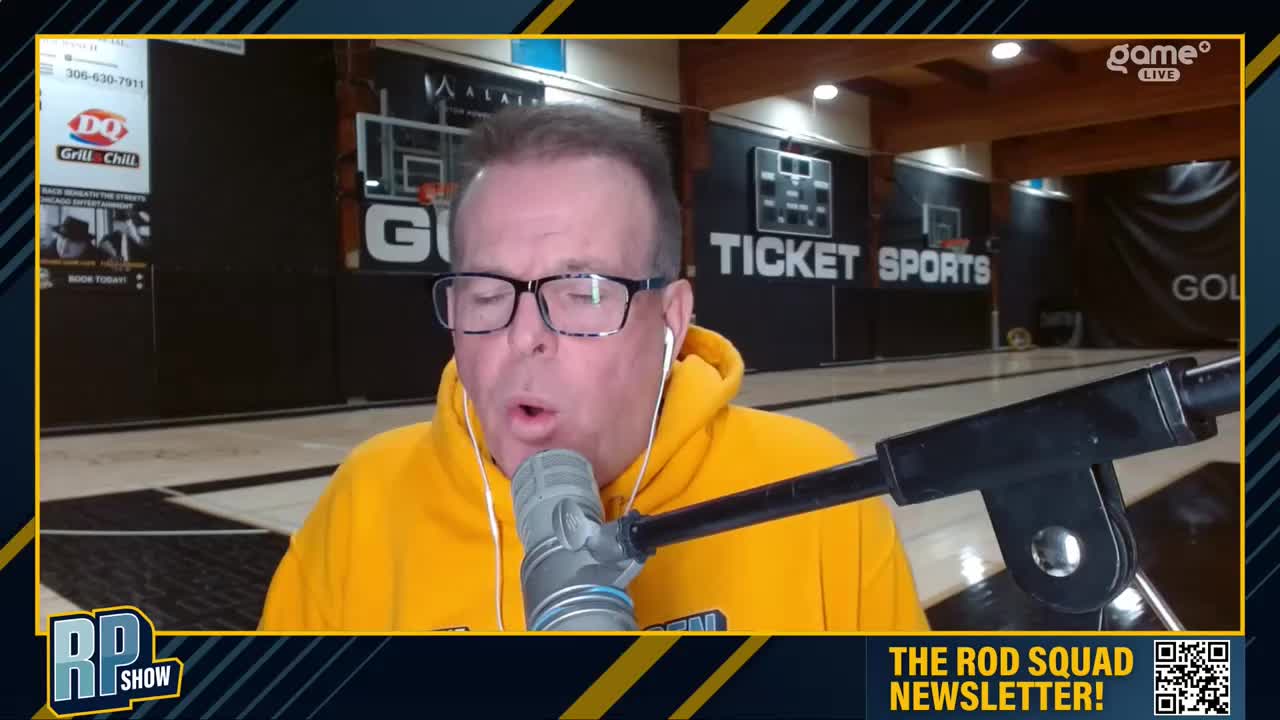 A man in a yellow hoodie speaks into a microphone, appearing to be broadcasting from a basketball court. Behind him, a "Ticket Sports" banner hangs, and the Game+ logo is visible in the corner.
