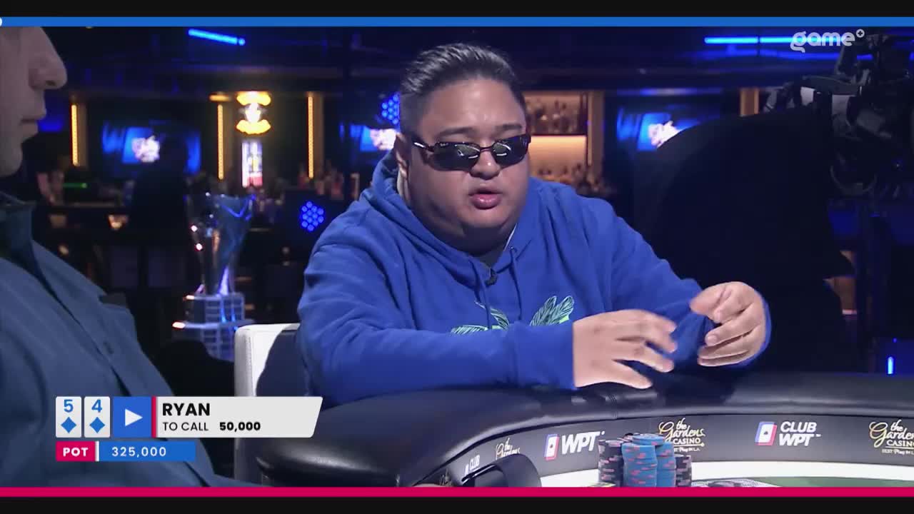 Ryan, wearing sunglasses and a blue hoodie, is mid-sentence at a poker table. The "Game+" logo is visible, and the screen shows he needs to call 50,000.
