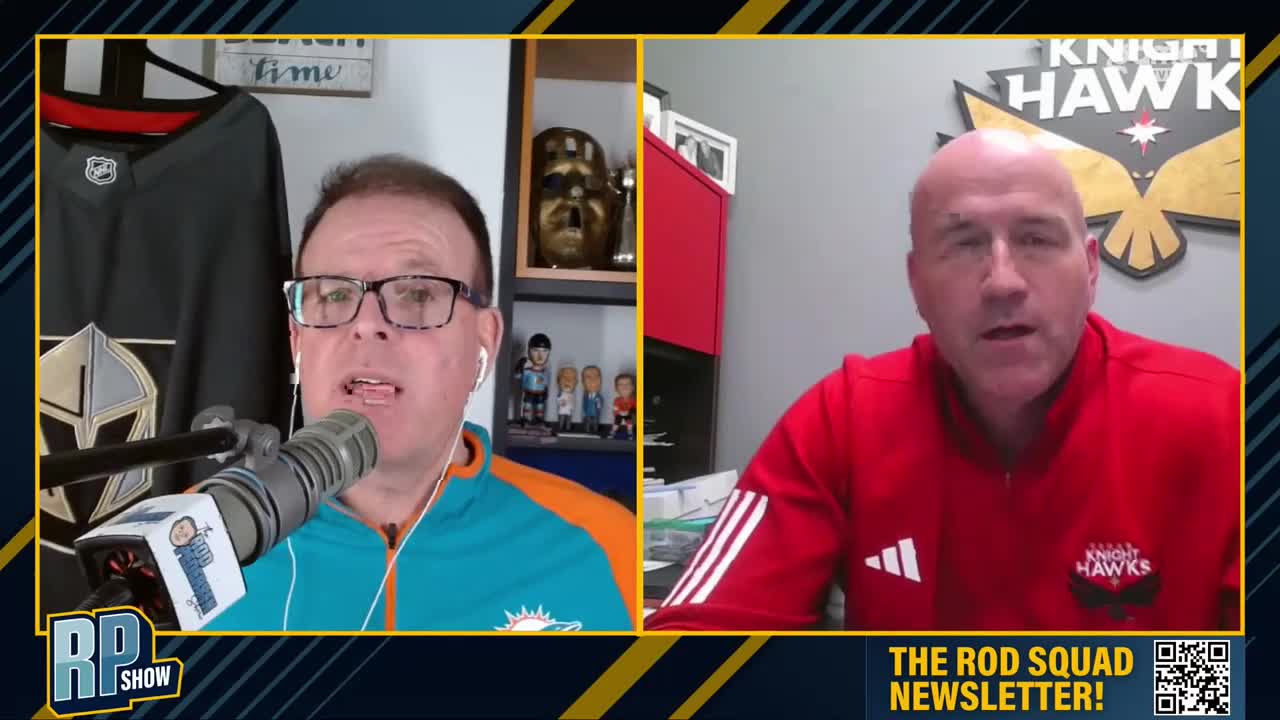 Two men are on a split screen, one in a teal and orange jacket, the other in a red jacket with a Knight Hawks logo. The man in teal speaks into a microphone, with a hockey jersey hanging behind him. Two men are on a split screen, one in a teal and orange jacket, the other in a red jacket with a Knight Hawks logo. The man in teal speaks into a microphone, with a hockey jersey hanging behind him.