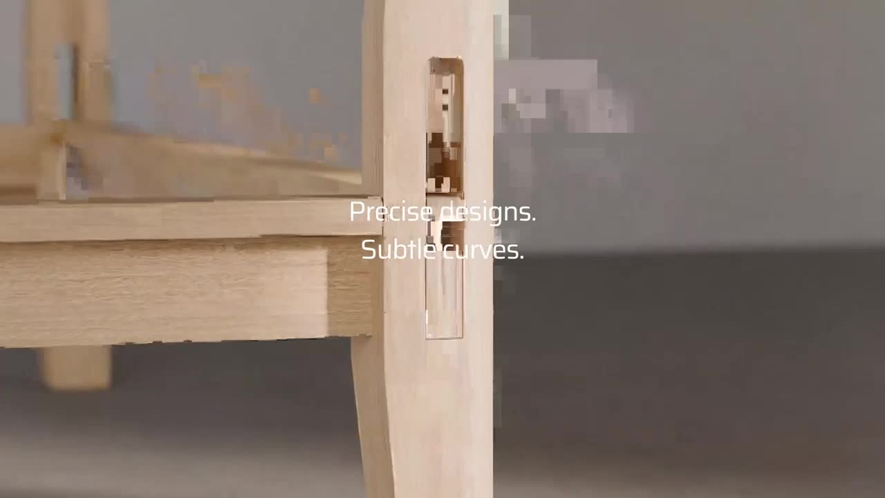The light wood of a chair leg is being worked on, revealing a precisely cut joint. Text overlays the image, reading "Precise designs. Subtle curves." The light wood of a chair leg is being worked on, revealing a precisely cut joint. Text overlays the image, reading "Precise designs. Subtle curves."