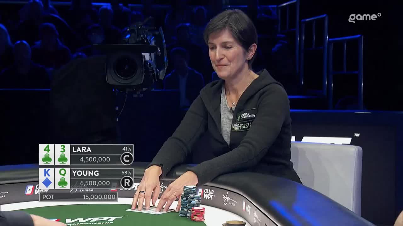 The woman in the black hoodie is about to play her cards. Stacks of chips sit on the felt in front of her, and the Game+ broadcast shows the pot is 15,000,000.