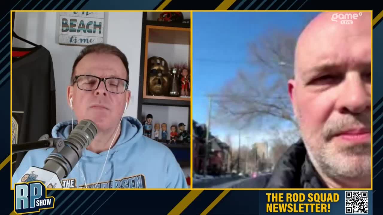 A man's face fills the right side of the screen, his gaze directed forward as he walks down a street in what looks like a Canadian city. On the left, another man wearing glasses and a light blue hoodie speaks into a microphone, with a shelf of bobbleheads behind him.