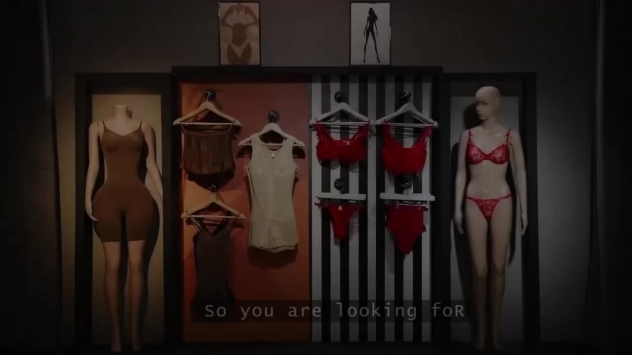 A mannequin in a brown full-body shaper stands to the left, while another in a red lace set is on the right. Racks between them display more lingerie, including corsets and bras.