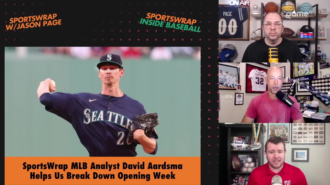 A baseball pitcher in a navy Seattle Mariners uniform winds up to throw. On the right, three men are on screen, two of them talking into microphones.