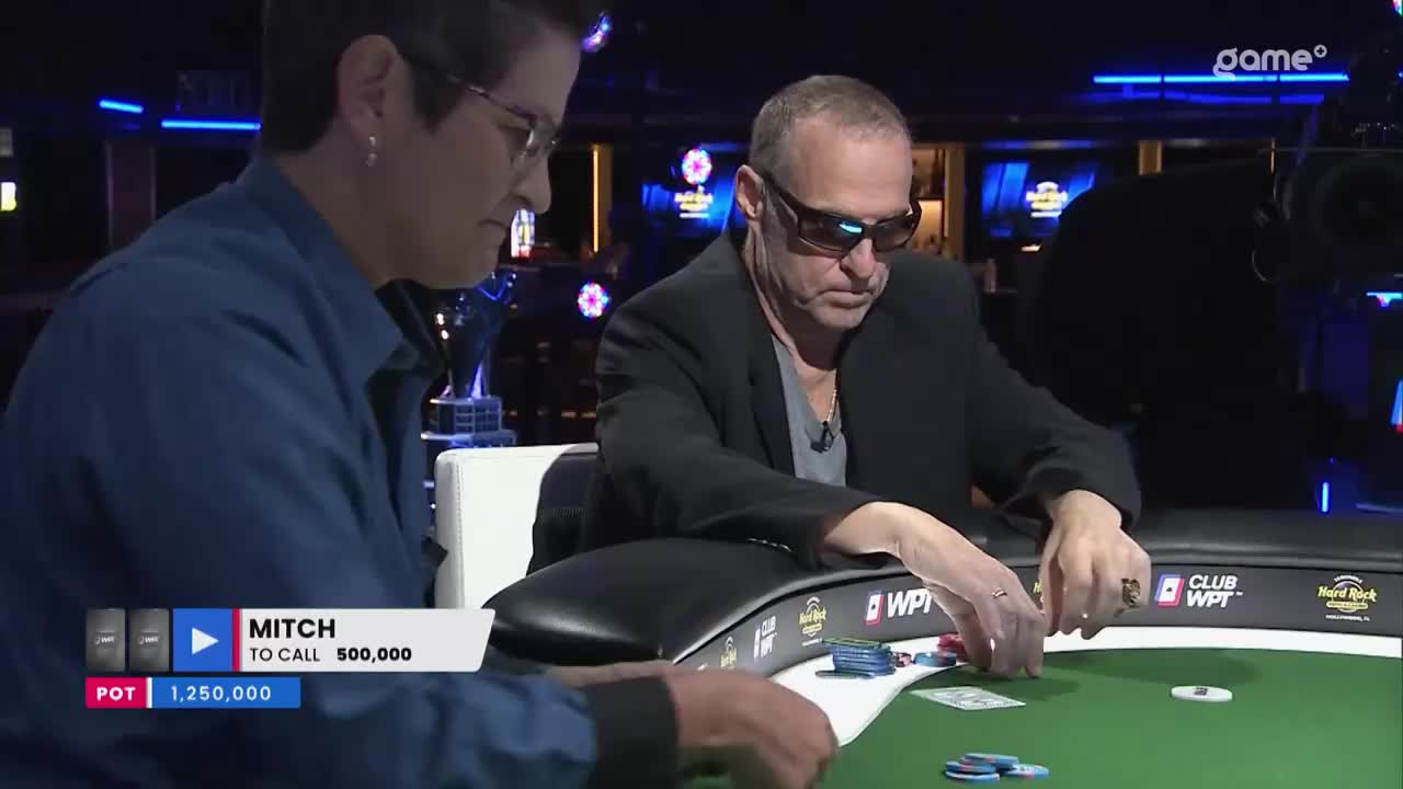 Mitch is about to call 500,000 in a pot of 1,250,000. The Game+ broadcast captures the tension as he reaches for chips.