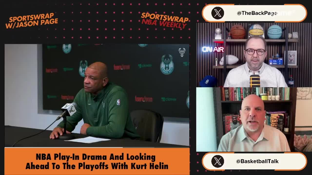 A man in a green jacket sits at a table, speaking into a microphone. Above him, two other men are on a video call, one wearing glasses and a light shirt, the other in a light green collared shirt.