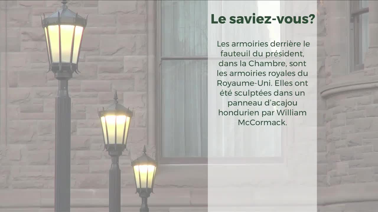 Three ornate street lamps, lit with a warm glow, stand in front of a stone building. The text suggests this is the Legislative Assembly of Ontario, and the lamps illuminate a window and a wall of the building.
