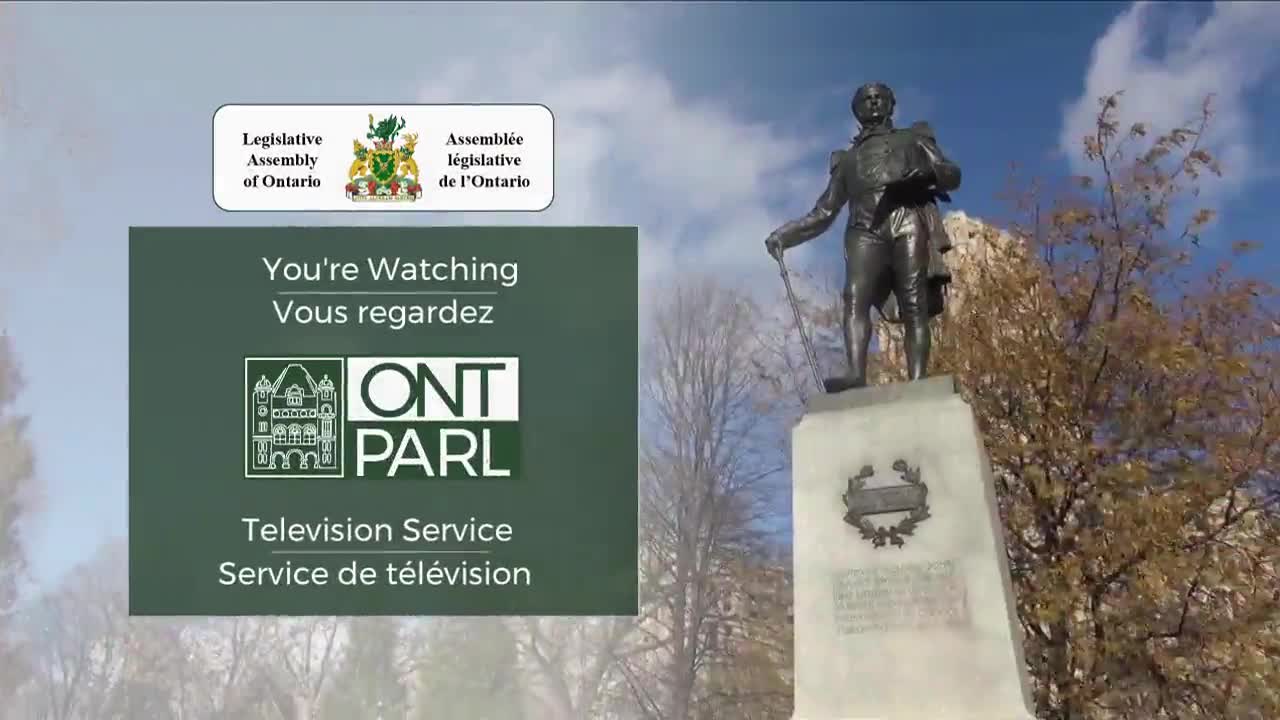 A statue of a man stands in front of a bright sky, with the Legislative Assembly of Ontario's logo and a television service graphic in the foreground. The image suggests a broadcast from the Ontario legislature.
